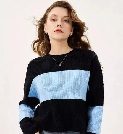 Woman wearing a black and blue striped sweater against a white background