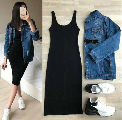 Black dress with denim jacket and white sneakers on a wooden floor.
