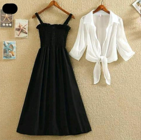 Black dress and white shirt on hangers against a beige wall.
